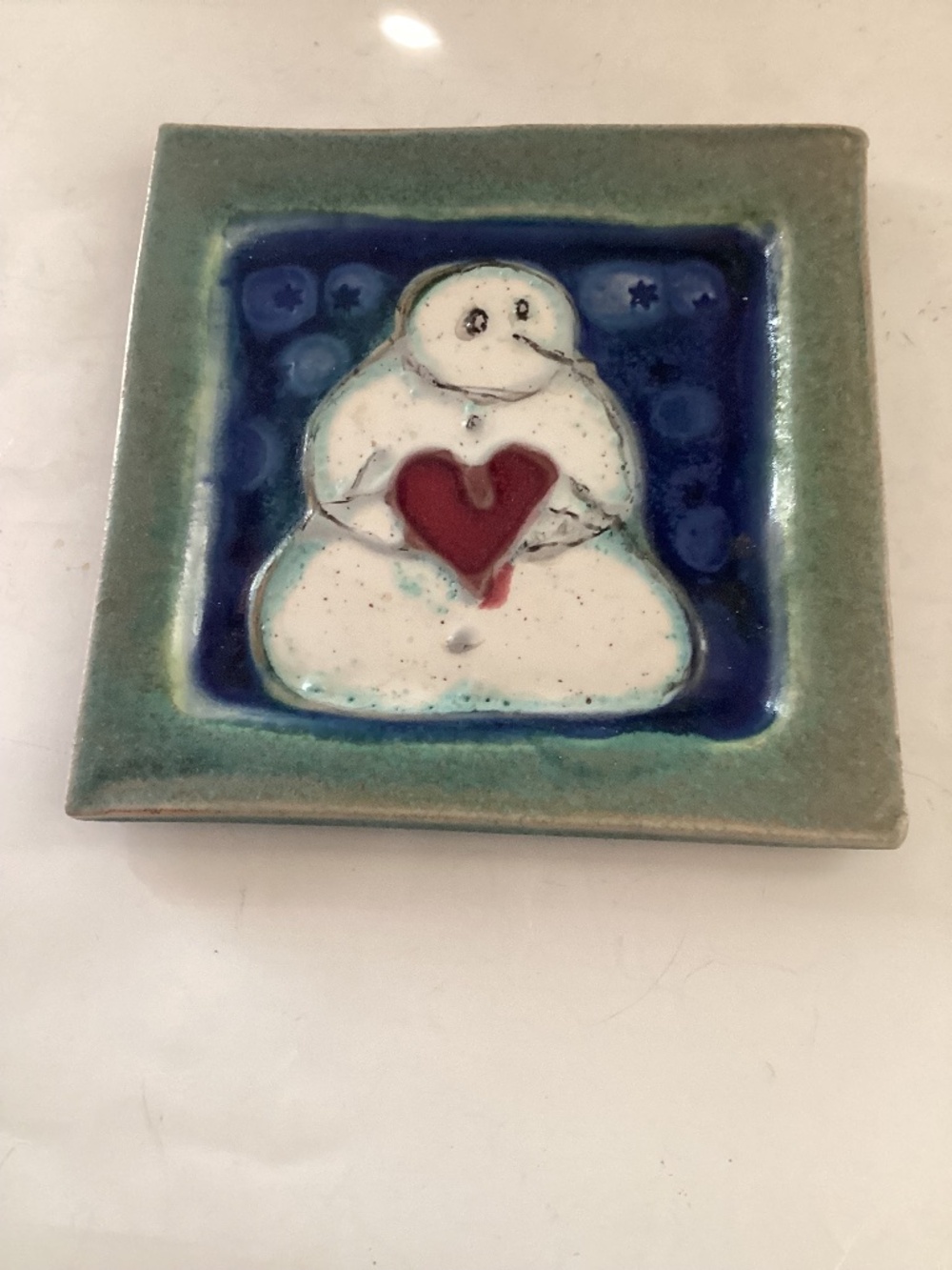 Handmade ceramic snowman dish in blue, green and white pottery